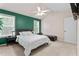 Bright bedroom with a green accent wall, a ceiling fan, and natural light from two windows at 3109 Gold Dust Ln, Willow Springs, NC 27592