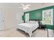 Bright bedroom with a green accent wall, a ceiling fan, and natural light from two windows at 3109 Gold Dust Ln, Willow Springs, NC 27592
