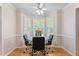 Bright breakfast nook features a glass table, black chairs, and a bay window at 3109 Gold Dust Ln, Willow Springs, NC 27592