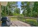Wooden deck with a grill, surrounded by lush trees at 3109 Gold Dust Ln, Willow Springs, NC 27592