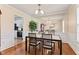 Elegant dining room with wood floors, mirrored accent wall, and access to the kitchen at 3109 Gold Dust Ln, Willow Springs, NC 27592