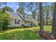 Traditional ranch home with dormer windows, attached two-car garage, lush landscaping and mature shade trees at 3109 Gold Dust Ln, Willow Springs, NC 27592