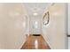 Hallway with hardwood floors, neutral paint, and decorative lighting fixture at 3109 Gold Dust Ln, Willow Springs, NC 27592