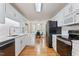 Bright kitchen featuring white cabinets, modern appliances, and a seamless transition to the breakfast area at 3109 Gold Dust Ln, Willow Springs, NC 27592