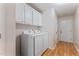 Clean laundry room featuring modern washer and dryer and convenient storage cabinets at 3109 Gold Dust Ln, Willow Springs, NC 27592