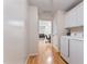 Laundry room with washer and dryer, built in cabinets, and hallway access at 3109 Gold Dust Ln, Willow Springs, NC 27592