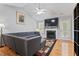 Living room features fireplace, gray sectional, high ceilings and outdoor access at 3109 Gold Dust Ln, Willow Springs, NC 27592