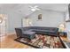 Spacious living room features vaulted ceilings, ceiling fan, and comfortable gray sectional couch at 3109 Gold Dust Ln, Willow Springs, NC 27592