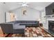 Living room with high ceilings, fireplace, large sectional, and door to backyard at 3109 Gold Dust Ln, Willow Springs, NC 27592