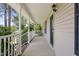 Charming covered front porch with white railings and ample space for outdoor seating at 3109 Gold Dust Ln, Willow Springs, NC 27592