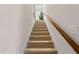 Carpeted stairway with wooden handrail, leading to an upper level at 3109 Gold Dust Ln, Willow Springs, NC 27592