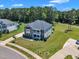 Aerial view of a well-manicured two-story home with beautiful landscaping and an expansive lawn at 326 S Parliament Way, Clayton, NC 27520