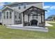 Inviting back deck featuring an entertainment area with a pergola, chairs, and an outdoor grill at 326 S Parliament Way, Clayton, NC 27520