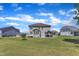 Backyard featuring a deck, outdoor kitchen, manicured lawn and gray siding on the home at 326 S Parliament Way, Clayton, NC 27520