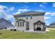 Large backyard featuring a deck, outdoor kitchen, lush lawn, and gray siding on the home at 326 S Parliament Way, Clayton, NC 27520