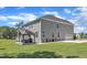 Lush backyard with outdoor kitchen, a well-manicured lawn, and gray siding on the home at 326 S Parliament Way, Clayton, NC 27520