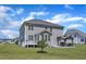 Backyard with an outdoor kitchen, deck, expansive lawn, and the gray siding of the home at 326 S Parliament Way, Clayton, NC 27520
