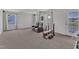 Spacious carpeted basement area complete with workout equipment and seating at 326 S Parliament Way, Clayton, NC 27520