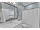 Stylish bathroom featuring white vanity, framed mirror, shower with curtain, and paint accents at 326 S Parliament Way, Clayton, NC 27520