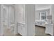 Bright bathroom adjacent to bedroom features a white vanity and updated fixtures at 326 S Parliament Way, Clayton, NC 27520