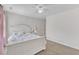 Neutral bedroom featuring carpet, a bed with floral bedding, and ceiling fan at 326 S Parliament Way, Clayton, NC 27520