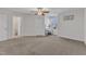 Carpeted bedroom with a window, ceiling fan, and en-suite bathroom at 326 S Parliament Way, Clayton, NC 27520