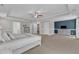 Bright primary bedroom featuring tray ceiling, ensuite bathroom, walk in closet, and stylish furnishings at 326 S Parliament Way, Clayton, NC 27520