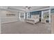 Spacious bedroom with tray ceiling, large windows, carpet, and decorative blue wall accent at 326 S Parliament Way, Clayton, NC 27520