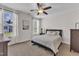 Comfortable bedroom with large windows, ceiling fan, neutral carpet, and ample natural light at 326 S Parliament Way, Clayton, NC 27520