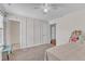 Bright bedroom features neutral walls, carpet, ceiling fan, and attached room access at 326 S Parliament Way, Clayton, NC 27520