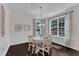 Bright dining room features classic chandelier, table and chairs, with large windows offering outdoor views at 326 S Parliament Way, Clayton, NC 27520