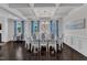 Elegant dining room with coffered ceiling, chandelier, and a large table with eight chairs at 326 S Parliament Way, Clayton, NC 27520