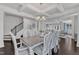 Open-concept dining room with a decorative table, chandelier, and views into the kitchen at 326 S Parliament Way, Clayton, NC 27520