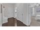 Inviting entryway featuring hardwood floors, neutral paint, and access to bathroom and bedroom at 326 S Parliament Way, Clayton, NC 27520