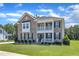 Beautiful two-story brick home with landscaped yard, black shutters and a welcoming front porch at 326 S Parliament Way, Clayton, NC 27520