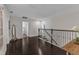 Open hallway with hardwood floors and access to various rooms at 326 S Parliament Way, Clayton, NC 27520