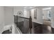 Inviting hallway with dark wood floors, decorative railing and architectural wall decor at 326 S Parliament Way, Clayton, NC 27520