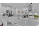 Gourmet kitchen features a large island with seating and stainless appliances with white cabinets and counters at 326 S Parliament Way, Clayton, NC 27520