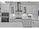 Gourmet kitchen features stainless appliances, double ovens, and white cabinets and counters at 326 S Parliament Way, Clayton, NC 27520