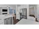 Gourmet kitchen features stainless appliances, white cabinets, granite countertops, and view of the living room at 326 S Parliament Way, Clayton, NC 27520