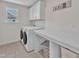 Bright laundry room equipped with washer, dryer, and folding table at 326 S Parliament Way, Clayton, NC 27520