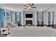 Bright living room featuring a fireplace, large windows, and contemporary furnishings at 326 S Parliament Way, Clayton, NC 27520