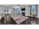 Cozy living room with a fireplace, mantel, large TV, and plenty of natural light at 326 S Parliament Way, Clayton, NC 27520