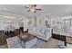 Open living area showcasing a transition to a dining room and kitchen. Hardwood floors at 326 S Parliament Way, Clayton, NC 27520
