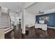 Open-concept living space with hardwood floors and staircase, transitioning into living area and home office at 326 S Parliament Way, Clayton, NC 27520