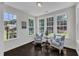 Bright sunroom boasts natural light through ample windows and features cozy seating area with two chairs at 326 S Parliament Way, Clayton, NC 27520