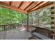 Back porch featuring wood floors, wooden railings, and lush green trees at 3263 S Jim Minor Rd Rd, Haw River, NC 27258
