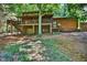 Rear view of log home featuring a spacious deck perfect for outdoor living and entertaining at 3263 S Jim Minor Rd Rd, Haw River, NC 27258