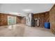 Spacious unfinished basement with brick walls and sliding glass door at 3263 S Jim Minor Rd Rd, Haw River, NC 27258