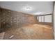 Unfinished basement with brick walls, carpet remnants, and drop ceiling at 3263 S Jim Minor Rd Rd, Haw River, NC 27258